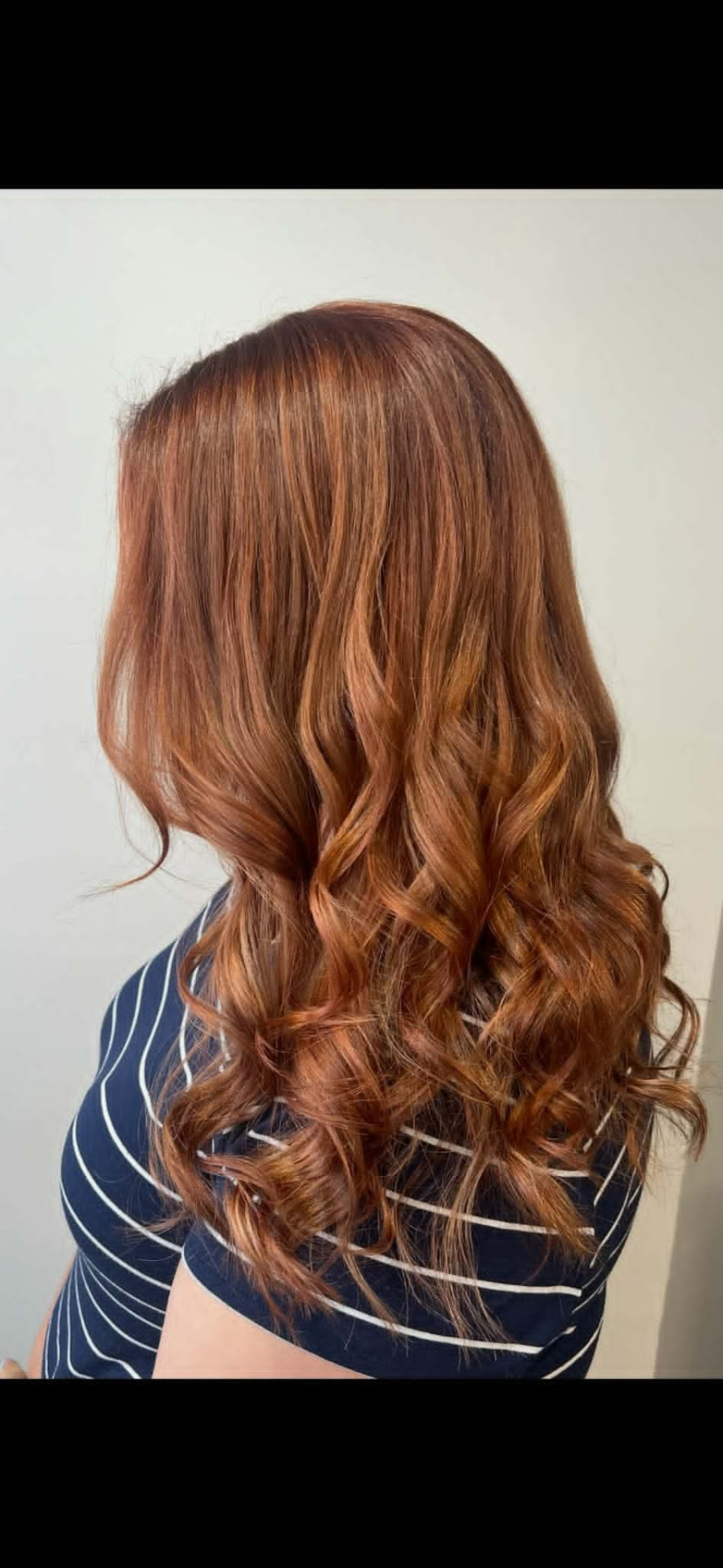 Warm copper balayage with long loose curls